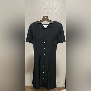 Cute Black dress 7 pearl buttons, cute tie accent in back.